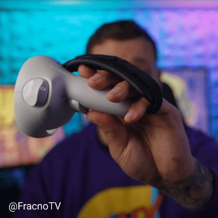 fracnotv youtuber holding a meta quest 2 controller with a protubevr prostrap cushion-pad on it