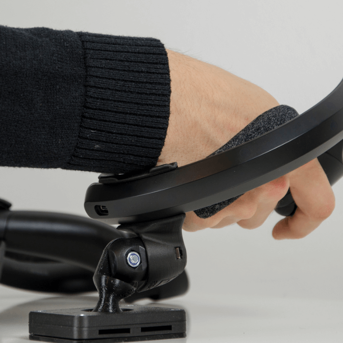 a black protas vr joystick with a valve index knuckle controller inclined forward by a right hand