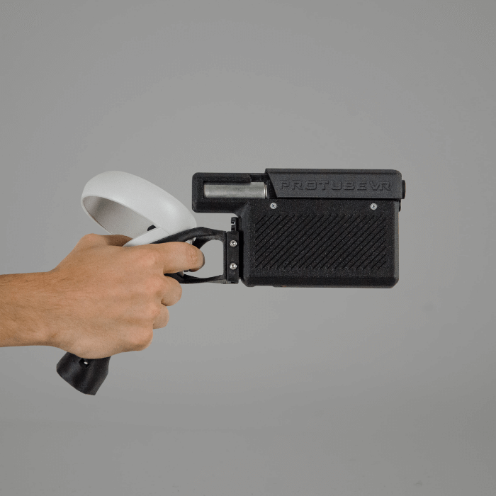 a provolver haptic pistol hold by a right hand on a neutral background